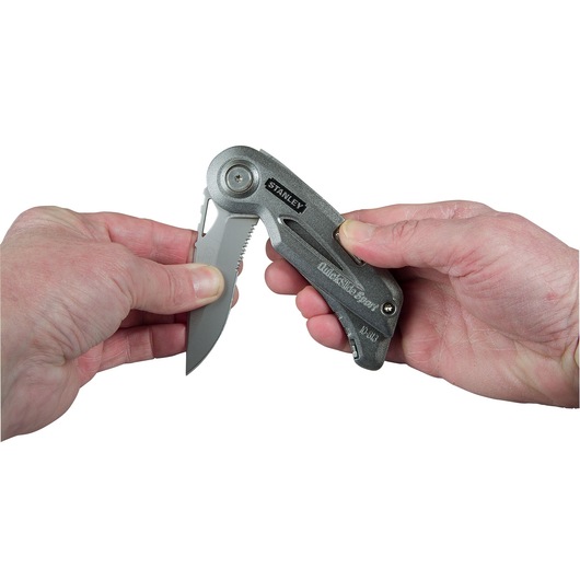 Photo of STANLEY 0-10-813 folding utility knife being opened with two hands, silver finish.
