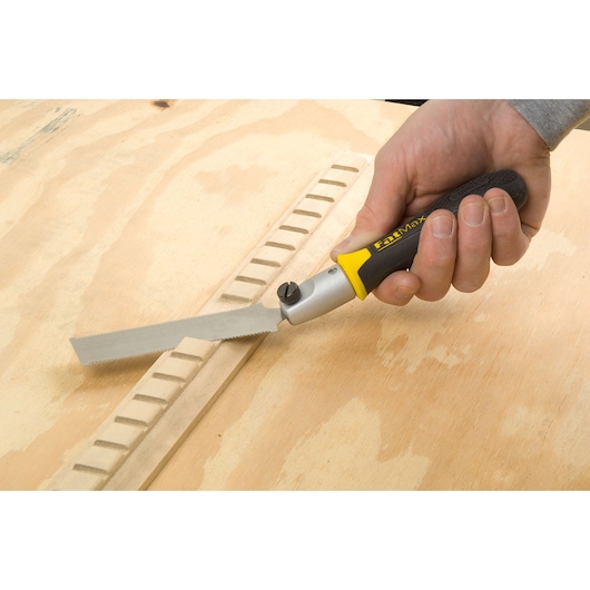 STANLEY 0-20-331 FatMax folding saw being used for woodworking, close-up of handle and blade.
