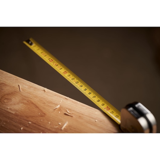 STANLEY 0-32-109 tape measure extended across wood surface, close-up photography.