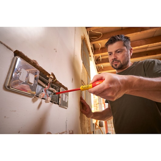 Photo of STANLEY 0-65-419 insulated screwdriver used on electrical outlet during installation.