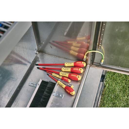 STANLEY 0-65-443 insulated screwdrivers with yellow-red handles, angled view in a metal toolbox.