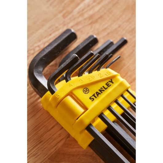 STANLEY 0-69-253 hex key set in yellow holder, close-up angled view on wood surface.
