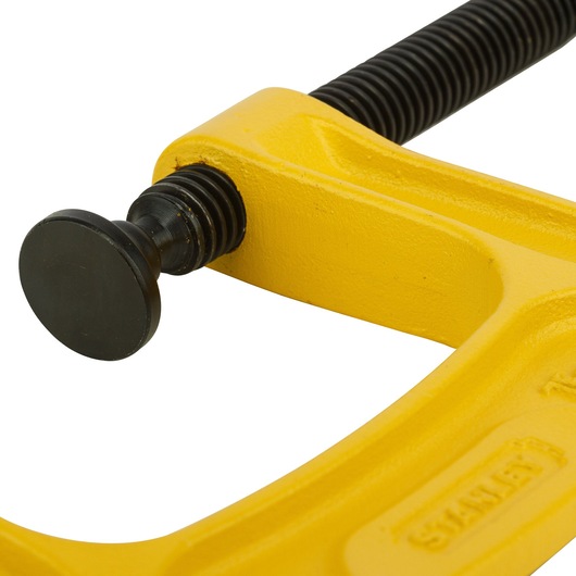 STANLEY 0-83-033 yellow C-clamp close-up, metal frame and screw, photography on white background.