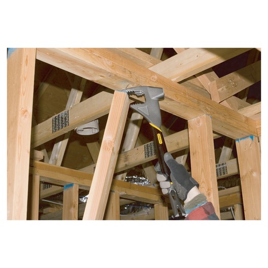 Stanley 1-55-099 adjustable wrench used on wooden framing, photography of construction context.