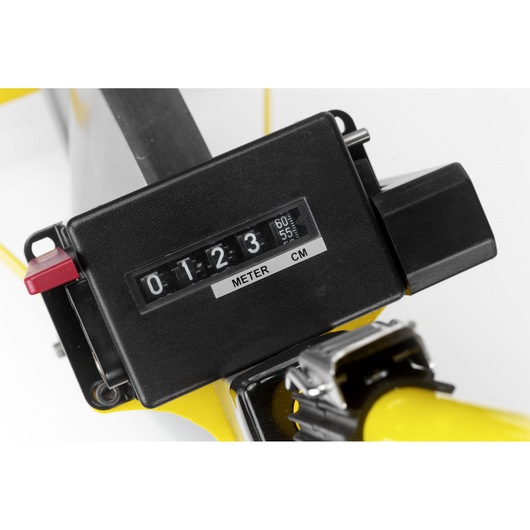 Close-up of a black metric measuring device with meter and centimeter display attached to a yellow tool.