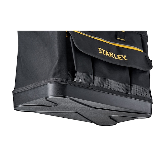 Stanley 1-96-183 tool bag, black fabric with yellow trim, reinforced hard plastic base, side angle photo.