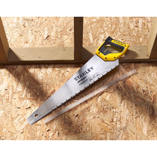 STANLEY 2-20-037 hand saw with yellow and black handle on wood panel, blade marked JETCUT 550mm.