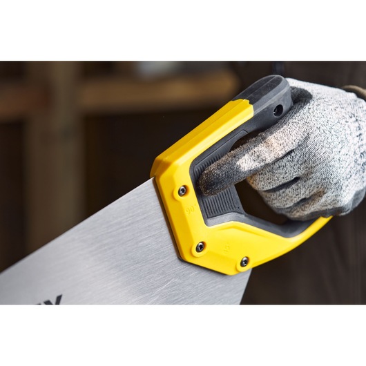 STANLEY 2-20-037 hand saw with yellow and black handle, close-up of handle gripped by a gloved hand.