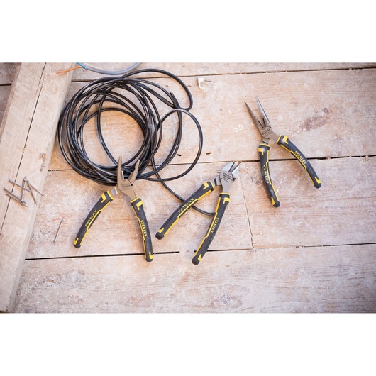 Photo of STANLEY 4-84-488 plier set with black and yellow handles on wooden surface, coiled wire nearby.