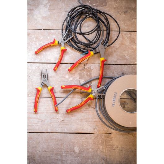 STANLEY 4-84-489 pliers set with red and yellow handles on wooden surface, shown with electrical wire, top view.