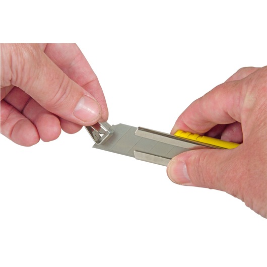 Photo of STANLEY 8-10-421 snap-off utility knife blade being broken off with safety cap, close-up.