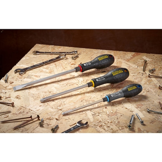 STANLEY FMHT0-62621 screwdriver set with black handles, photographed on wooden board with scattered tools.