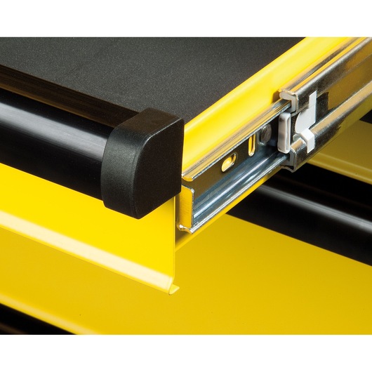 STANLEY FMHT0-74027 tool cabinet drawer with yellow metal, black trim, and metal ball-bearing slide, close-up angle.