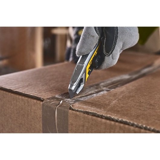 STANLEY FMHT10592-0 utility knife opening cardboard box, close-up view.