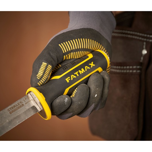 STANLEY FMHT16693-0 chisel with FATMAX handle, held in gloved hand, close-up photo.
