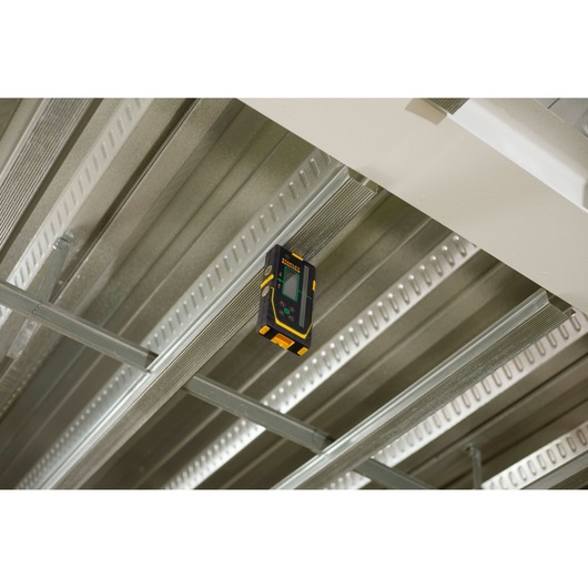Photo of STANLEY FMHT77653-0 laser detector attached to a metal ceiling frame, showing front display.