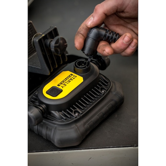 Photo of STANLEY FMHT81507-1 digital inflator being connected with power cable, close-up view.