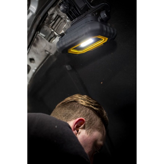 STANLEY FMHT81507-1 work light mounted under car hood, illuminating engine area during repair.