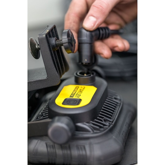 STANLEY FMHT81507-1 handheld device with yellow label, close-up with power connector and clamp.
