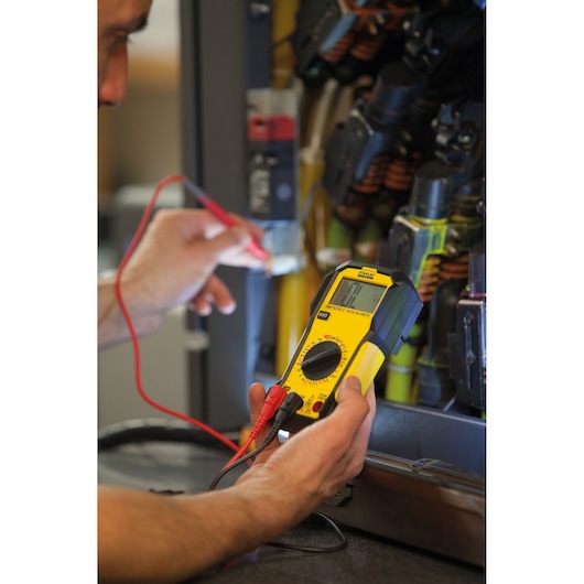 Photo of STANLEY FMHT82565-0 digital multimeter being used to test electrical panel wiring.