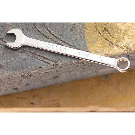 STANLEY FMMT13034-0 combination wrench, silver, 13mm, shown on a textured stone surface.