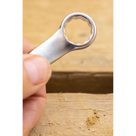 STANLEY FMMT13036-0 close-up photo of silver box-end wrench held against wooden surface.