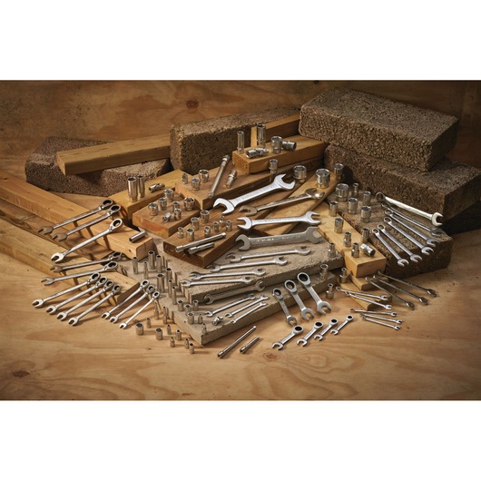 STANLEY FMMT13067-0 photography of assorted wrenches and sockets arranged on wood and concrete blocks.