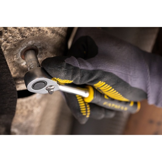 STANLEY FMMT17198-0 ratchet wrench held by gloved hand tightening a bolt, close-up action view.