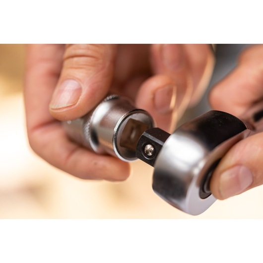 STANLEY FMMT17231-0 photography of a close-up hand attaching socket to ratchet wrench.