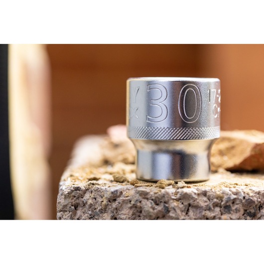 STANLEY FMMT17247-0 socket, metallic finish, close-up on a rough surface, photography.
