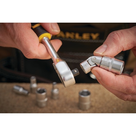 STANLEY FMMT18008-0 socket wrench and universal joint close-up, photography of hand holding tool.