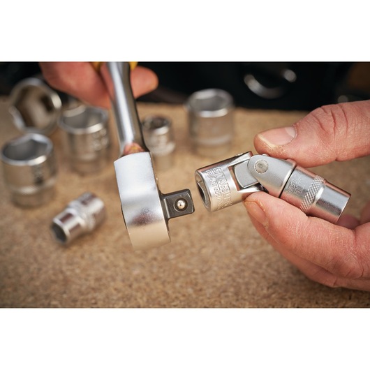 STANLEY FMMT18011-0 socket and universal joint photography, close-up, chrome finish, hand holding tool.