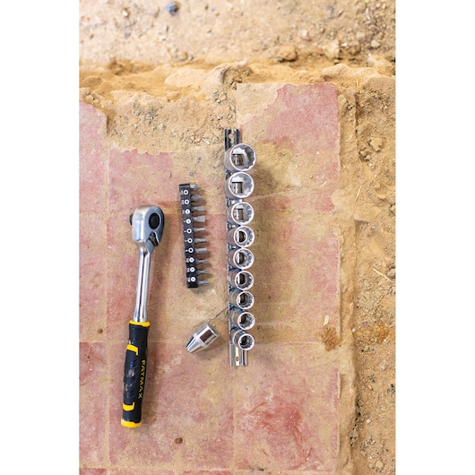 STANLEY FMMT82679-0 socket and bit set with ratchet, viewed from above on construction surface.