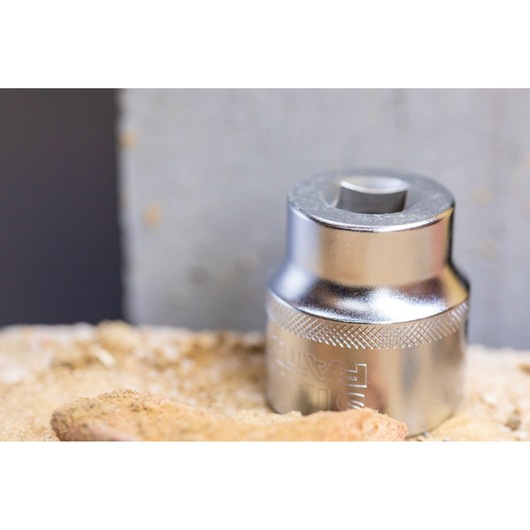 STANLEY FMMT82679-0 chrome socket, close-up, on sandy surface.