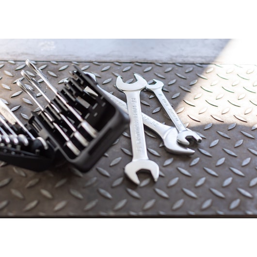STANLEY FMMT82901-0 wrench set and open-end wrenches on textured metal surface, side angle.