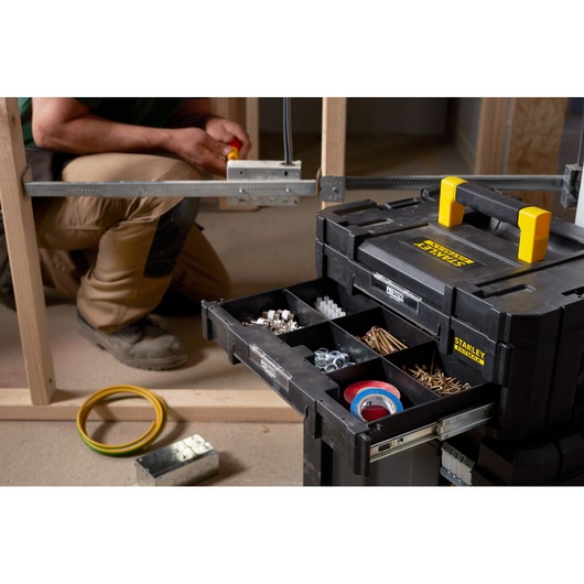 STANLEY FMST1-71969 tool organizer with open drawer showing compartments of fasteners and tape, front angle.