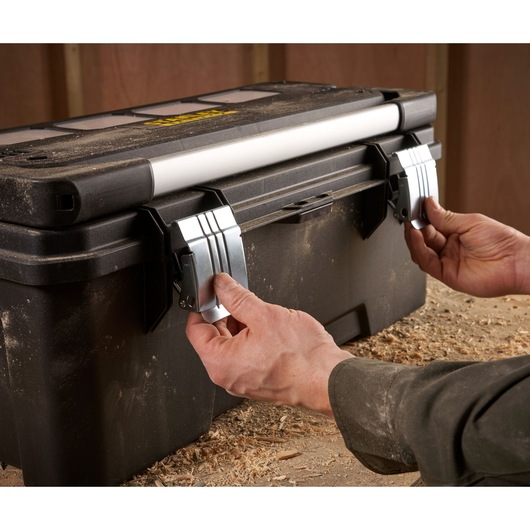 STANLEY FMST1-75791 tool box with metal latches, photo shows hands opening box in workshop.