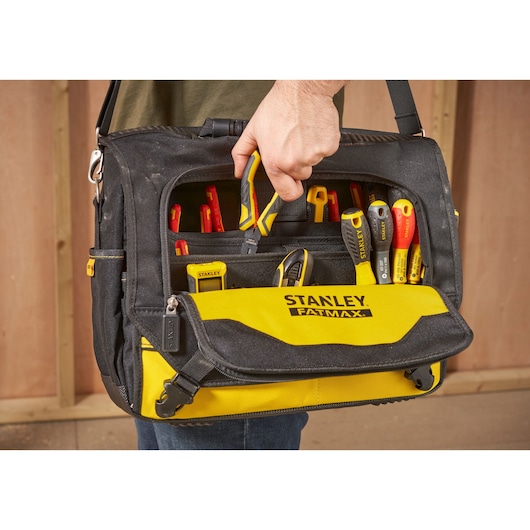 STANLEY FMST1-80149 tool bag with yellow front, filled with hand tools, front view, indoor setting.