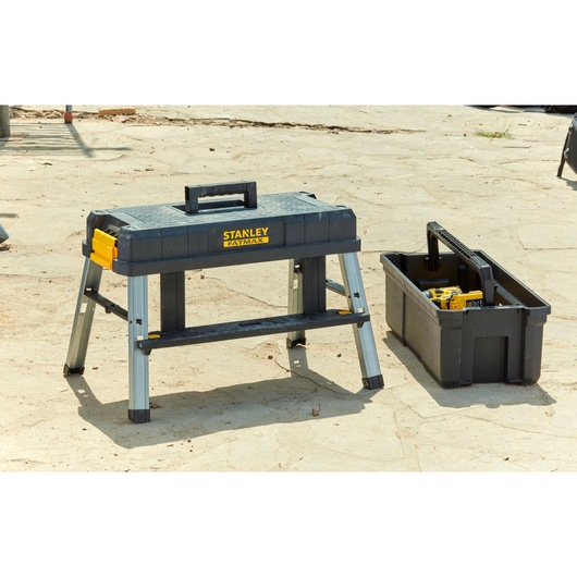 STANLEY FMST81083-1 portable workbench and tool box outdoors, black and yellow, photography of product.