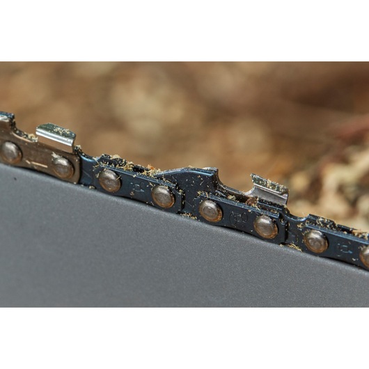 STANLEY SFMCCS630M1 chainsaw blade close-up showing metal teeth and sawdust.