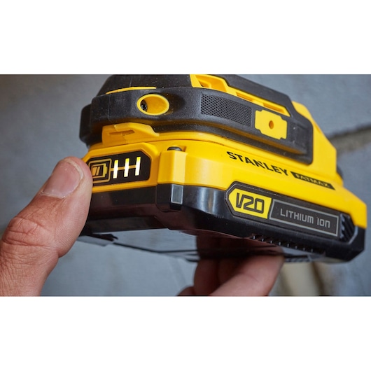 Stanley SFMCD711C2S V20 Lithium Ion battery close-up, showing indicator and yellow-black casing.