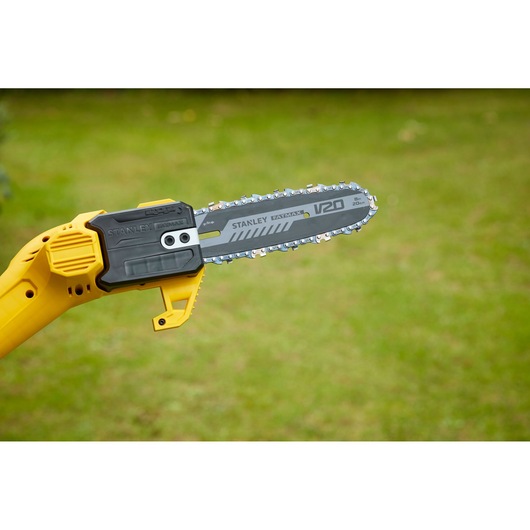 STANLEY SFMCPS620M1 cordless pole saw with yellow and black body, side view outdoors.