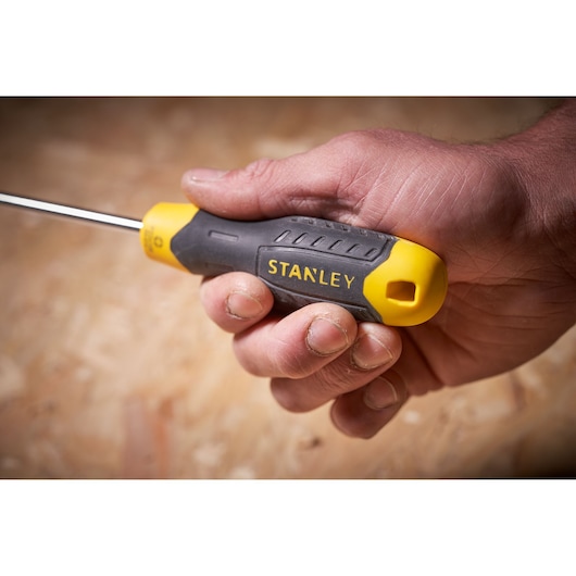 Photo of STANLEY STHT0-60276 screwdriver with yellow and black handle held in hand.