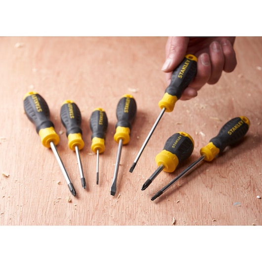 STANLEY STHT16195-0 screwdriver set, black and yellow handles, six pieces on wood surface, photography angle.