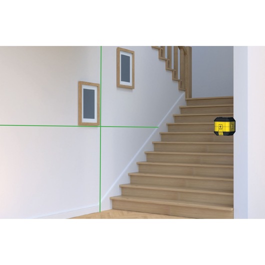 STANLEY STHT77499-1 laser level projecting green lines on staircase wall, interior angle view.