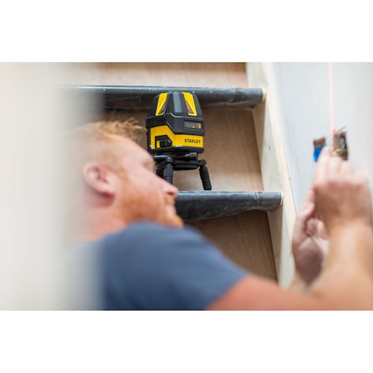 STANLEY STHT77514-1 laser level tool used for wall alignment in construction, photography category.