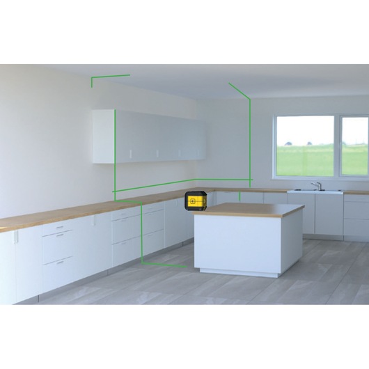 STANLEY STHT77592-1 laser level placed on kitchen island, projecting green lines across white cabinets.