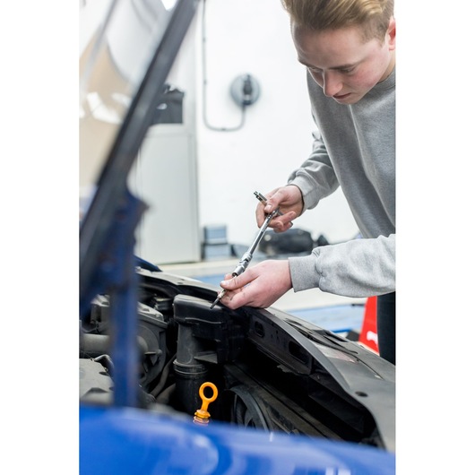 STANLEY STHT80888-0 ratchet wrench used for car engine repair, photography of tool in action.