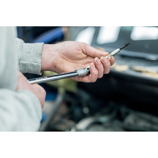 STANLEY STHT81015-0 socket wrench held in hand, close-up, tool category, automotive context.