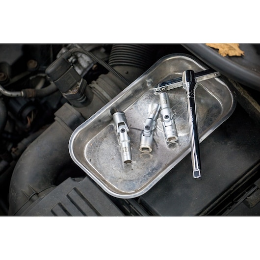 STANLEY STHT81015-0 socket wrench and sockets set on metal tray during automotive maintenance.